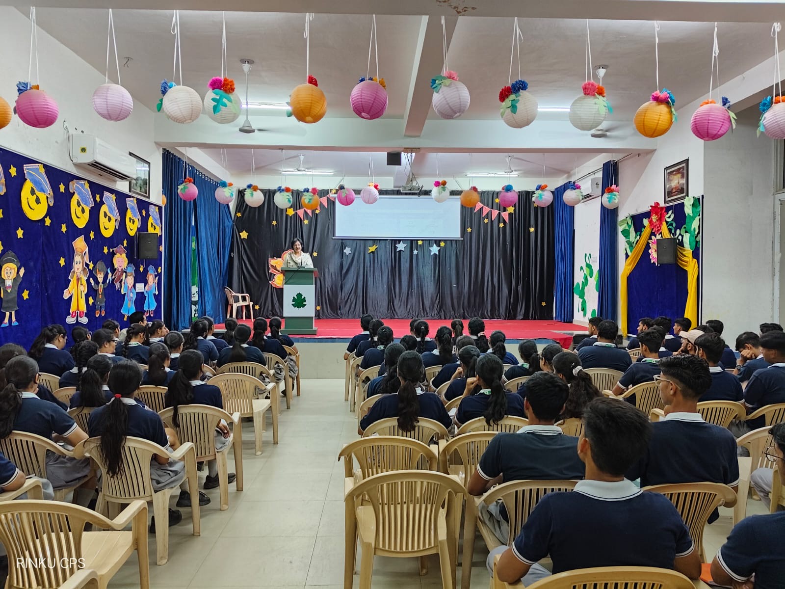 Students attending a school presentation in the auditorium